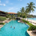Couple planning cheap holidays at a modern hotel